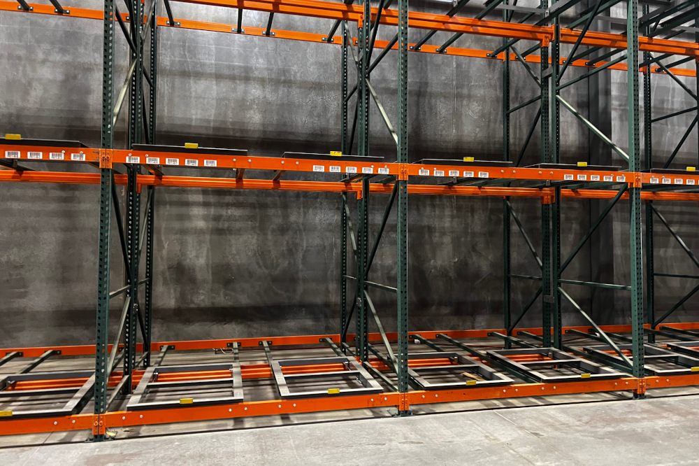Pushback pallet racking with cart rails and load beams